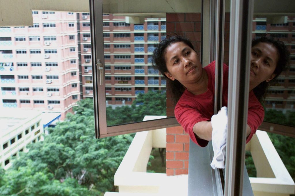 maid cleaning window